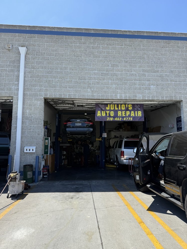 Julio’s Auto Repair service bay and Unit 405 sign with a customer vehicle at the entrance