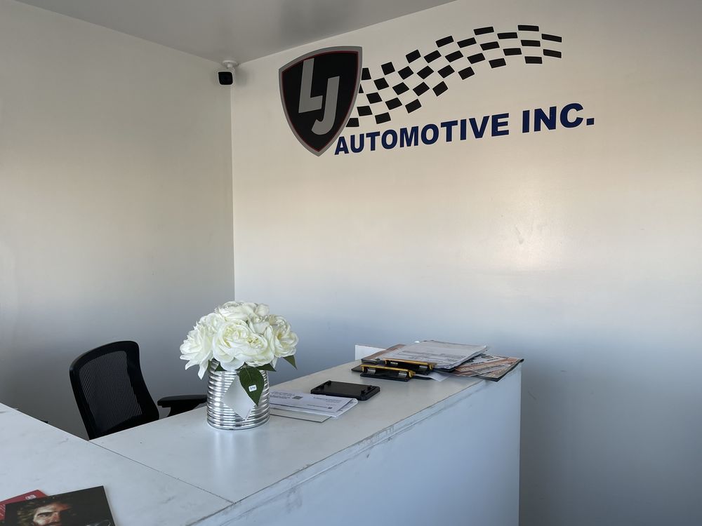Reception desk and LJ Automotive logo on the wall